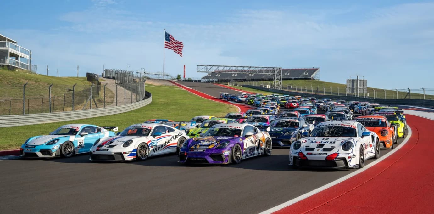 The Porsche Sprint Challenge grid queued nose to tail on the circuit